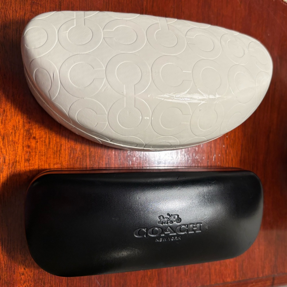 COACH - Pair of hard shell cases for either sunglasses or glasses.
